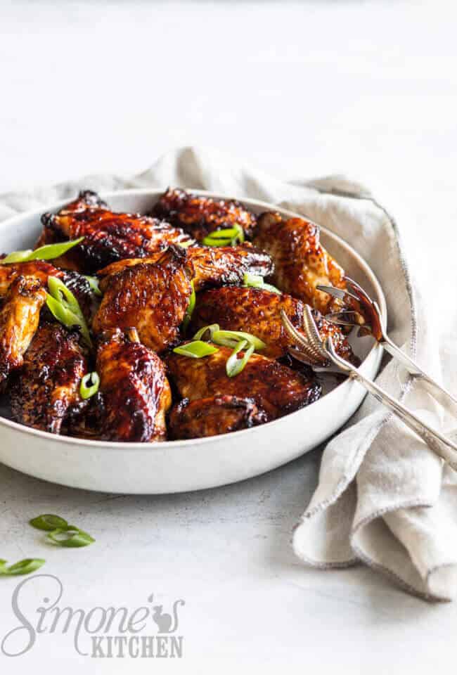 Kippenboutjes uit de airfryer. Bord met stapel kippenboutjes